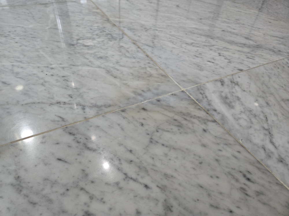 Close view of polished natural stone flooring with clean grout lines